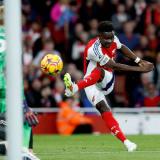 Bukayo Saka kicking a football